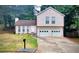 Charming two-story home with a well-maintained lawn and a convenient two-car garage at 849 Cadet Nw Ct, Lilburn, GA 30047