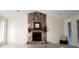 Inviting living room featuring a floor-to-ceiling stone fireplace and large windows at 849 Cadet Nw Ct, Lilburn, GA 30047