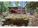 Beautiful backyard with lush landscaping, a charming pond, and multiple outdoor entertaining areas at 1890 Spalding Dr, Atlanta, GA 30350
