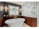 Luxurious bathroom with soaking tub under decorative window and separate glass enclosed shower at 1890 Spalding Dr, Atlanta, GA 30350