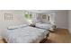 Bright bedroom featuring two beds, light hardwood floors, and stained-glass window at 1890 Spalding Dr, Atlanta, GA 30350