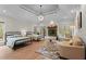 Spacious bedroom with two beds, decorative fireplace, and natural light from large windows at 1890 Spalding Dr, Atlanta, GA 30350
