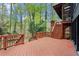 Spacious wooden deck with views of the surrounding trees and multi-level access points at 1890 Spalding Dr, Atlanta, GA 30350