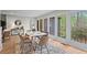 Bright dining room with large windows and modern furnishings overlooking a beautiful wooded area at 1890 Spalding Dr, Atlanta, GA 30350