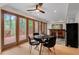 Dining room with hardwood floors, ceiling fan, black table and four chairs at 1890 Spalding Dr, Atlanta, GA 30350
