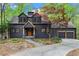 Charming two-story home featuring a dark exterior and complemented by lush greenery at 1890 Spalding Dr, Atlanta, GA 30350