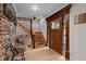 Bright foyer with hardwood floors, stairs, a decorative front door, and wood trim at 1890 Spalding Dr, Atlanta, GA 30350