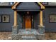 Close-up of the front door with stone accents, a wreath, and a charming entrance at 1890 Spalding Dr, Atlanta, GA 30350