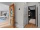 Hallway featuring wood floors and decorative doors leading to the kitchen and bathroom at 1890 Spalding Dr, Atlanta, GA 30350