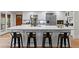 Spacious kitchen with white cabinetry, stainless steel appliances, and a large center island with barstools at 1890 Spalding Dr, Atlanta, GA 30350