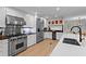 Bright kitchen with stainless steel appliances, white cabinets, and a large island with a sink at 1890 Spalding Dr, Atlanta, GA 30350
