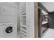 Convenient laundry room with washer, dryer, shelving, and easy access to the nearby bathroom at 1890 Spalding Dr, Atlanta, GA 30350