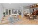 Open-concept space with kitchen, dining, and living areas featuring hardwood floors and modern decor at 1890 Spalding Dr, Atlanta, GA 30350