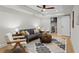 Living room area with hardwood floors, grey sofa, chairs, and side tables at 1890 Spalding Dr, Atlanta, GA 30350