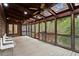 Spacious screened-in porch with wood ceilings and plenty of natural light at 1890 Spalding Dr, Atlanta, GA 30350