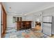 View of wet bar featuring two stools and stainless steel refrigerator at 1890 Spalding Dr, Atlanta, GA 30350
