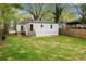 Spacious backyard with a green lawn and wooden fence, complemented by a small porch with stairs at 244 Birch St, Atlanta, GA 30354