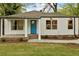 Charming white home with a bright blue front door and inviting front porch at 244 Birch St, Atlanta, GA 30354