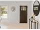 Bright foyer with a decorative mirror, modern table, and a view to the outside at 244 Birch St, Atlanta, GA 30354