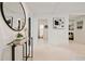 Bright white hallway featuring a large round mirror and views into other rooms at 244 Birch St, Atlanta, GA 30354