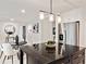 Kitchen with a granite countertop island, stainless steel refrigerator, and decorative lighting at 244 Birch St, Atlanta, GA 30354