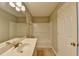 Bathroom featuring a tiled floor, a bathtub with shower, a white sink vanity, and neutral wall color at 3938 Stillwater Dr, Duluth, GA 30096