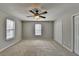 Large bedroom with neutral carpet, ceiling fan and natural light from a window at 3938 Stillwater Dr, Duluth, GA 30096