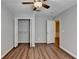 Bedroom with wood flooring, ceiling fan, closet and doorway to another room, and neutral walls at 3938 Stillwater Dr, Duluth, GA 30096