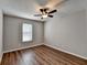 Bedroom with hardwood flooring, ceiling fan, window with blinds, and neutral wall color at 3938 Stillwater Dr, Duluth, GA 30096