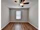 Bedroom featuring hardwood flooring, ceiling fan, window with blinds, and neutral wall color at 3938 Stillwater Dr, Duluth, GA 30096