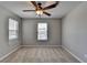 Bedroom featuring carpet, ceiling fan, windows with blinds, and neutral wall color at 3938 Stillwater Dr, Duluth, GA 30096