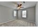 Bedroom with carpet, ceiling fan, two windows with blinds, and neutral wall color at 3938 Stillwater Dr, Duluth, GA 30096