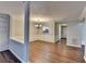 Dining area with hardwood floors, wainscoting, and chandelier with views of the entry hallway at 3938 Stillwater Dr, Duluth, GA 30096