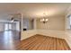 Dining area with wood floors, chandelier, decorative trim, and view of the fireplace at 3938 Stillwater Dr, Duluth, GA 30096