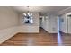 Dining area showcasing wood floors, chandelier, decorative trim, and view of the hallway at 3938 Stillwater Dr, Duluth, GA 30096