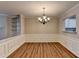 Dining area showcasing wood floors, chandelier, decorative trim, and kitchen view at 3938 Stillwater Dr, Duluth, GA 30096