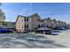 Street view of the townhome complex showing a row of townhomes and a parking lot at 3938 Stillwater Dr, Duluth, GA 30096
