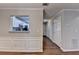 Hallway showcasing the kitchen, hardwood floors, decorative trim, and neutral paint at 3938 Stillwater Dr, Duluth, GA 30096