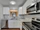 Modern kitchen features white cabinets, stainless steel appliances, granite countertops and stylish backsplash at 3938 Stillwater Dr, Duluth, GA 30096