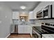 Modern kitchen with stainless steel appliances and white cabinets at 3938 Stillwater Dr, Duluth, GA 30096