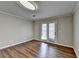 Bright room with wood floors, new light fixture and glass door to the exterior at 3938 Stillwater Dr, Duluth, GA 30096