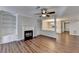 Inviting living room featuring a fireplace, built-in shelving, and wood floors at 3938 Stillwater Dr, Duluth, GA 30096