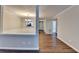 Open-concept living area with hardwood floors, wainscoting detail, and chandelier viewed from dining area at 3938 Stillwater Dr, Duluth, GA 30096