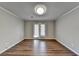 Well-lit living room featuring new floors and a glass door to the exterior at 3938 Stillwater Dr, Duluth, GA 30096