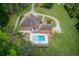 Stunning aerial view of the property showcasing the in-ground pool, lush landscaping, and circular driveway at 5040 Fawn Valley Dr, Loganville, GA 30052