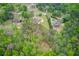 Overhead view of the property featuring lush trees and landscaping surrounding the house and pool at 5040 Fawn Valley Dr, Loganville, GA 30052