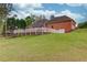 Expansive backyard with lush lawn, patio, white fence, and mature trees, perfect for outdoor enjoyment at 5040 Fawn Valley Dr, Loganville, GA 30052