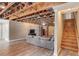 Open basement layout with exposed ceiling, vinyl floors, and staircase with access to main floor at 5040 Fawn Valley Dr, Loganville, GA 30052