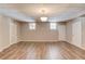 Large basement showcasing wood-look flooring, white doors, and windows for plenty of natural light at 5040 Fawn Valley Dr, Loganville, GA 30052