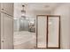 Bright bathroom features a soaking tub, framed shower and custom cabinets at 5040 Fawn Valley Dr, Loganville, GA 30052